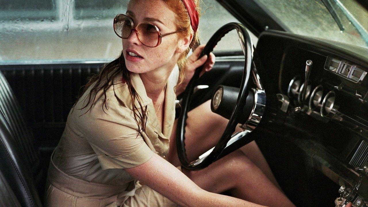 The Lady in the Car with Glasses and a Gun backdrop